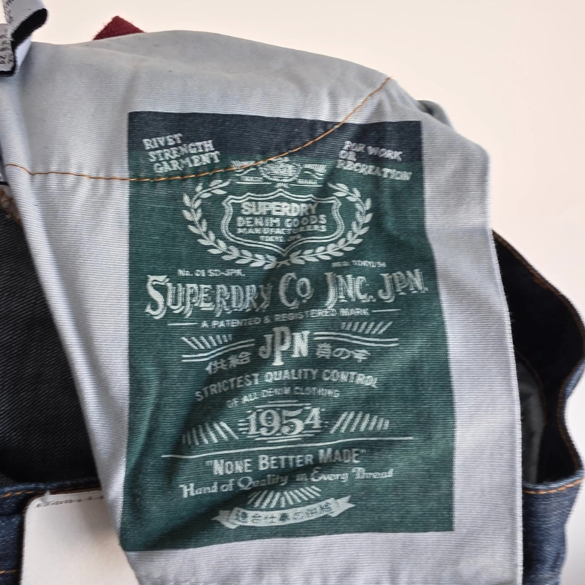Superdry blue selvedge jeans with contrast stitching and lightly distressed details.