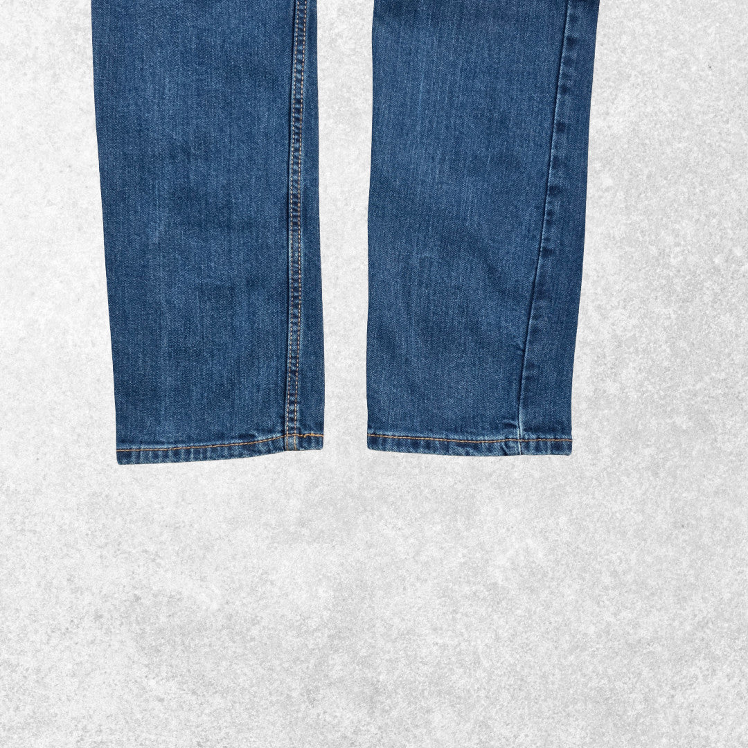 Levi's blue straight jeans with distressed patches and natural wear, made in USA.