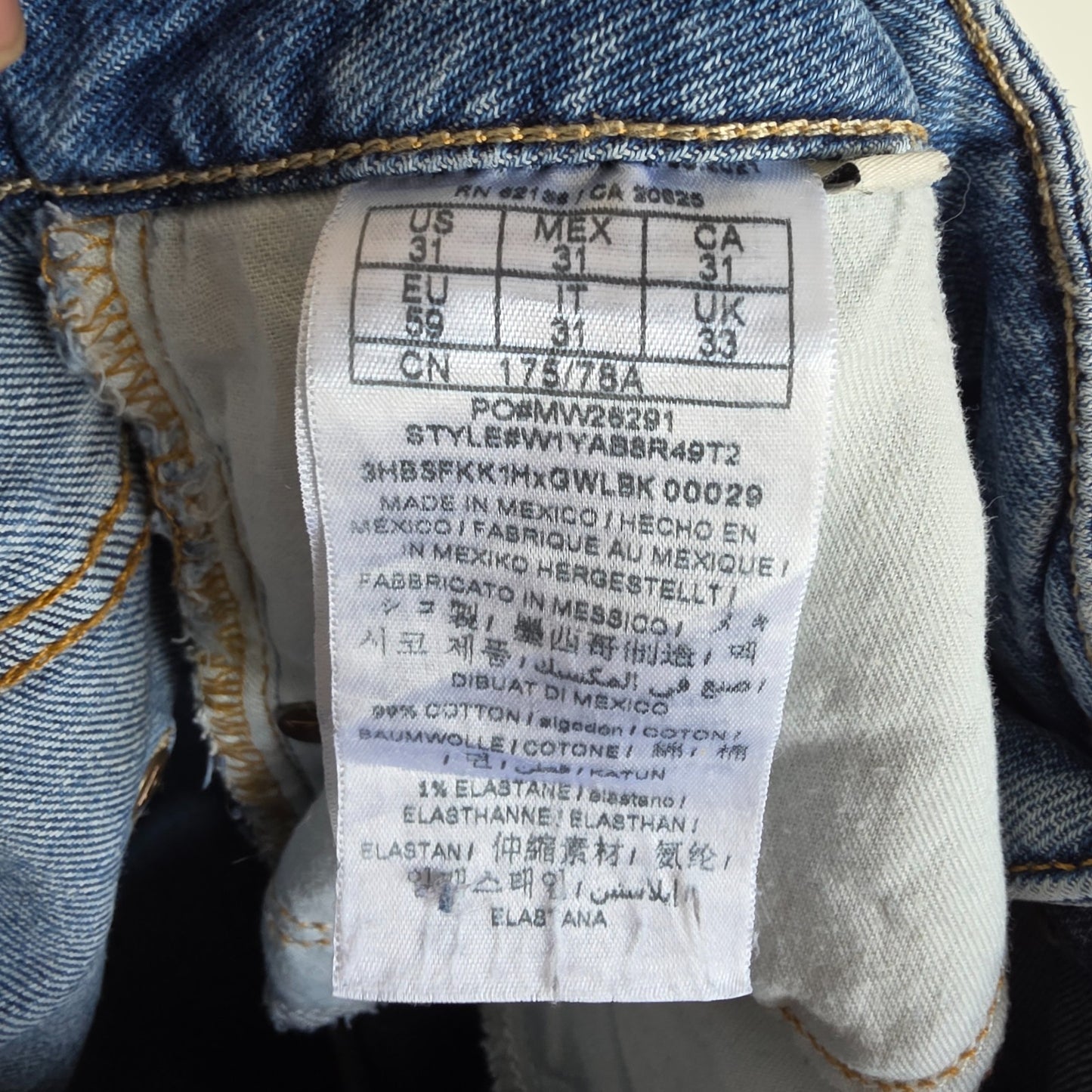 Vintage Guess blue cropped straight jeans with distressed details and high rise fit.