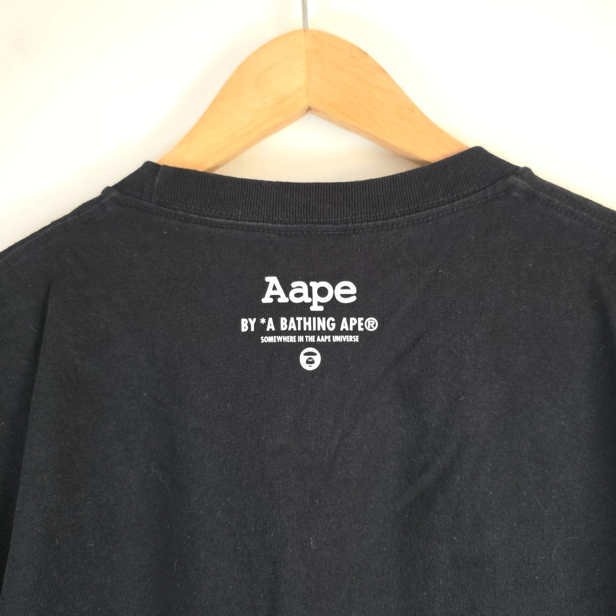 AAPE by A Bathing Ape black T-shirt with large camo ape head graphic and branded sleeve.
