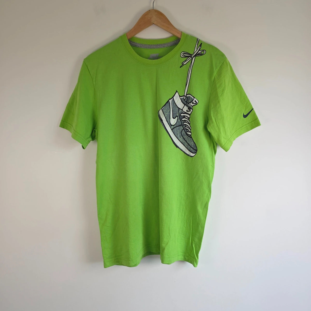Nike graphic T-shirt bright green sneaker print Y2K streetwear style.