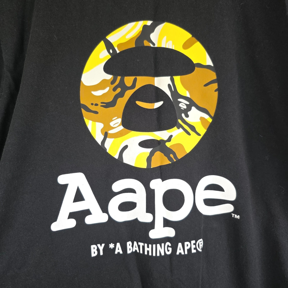 AAPE by A Bathing Ape black T-shirt with large camo ape head graphic and branded sleeve.