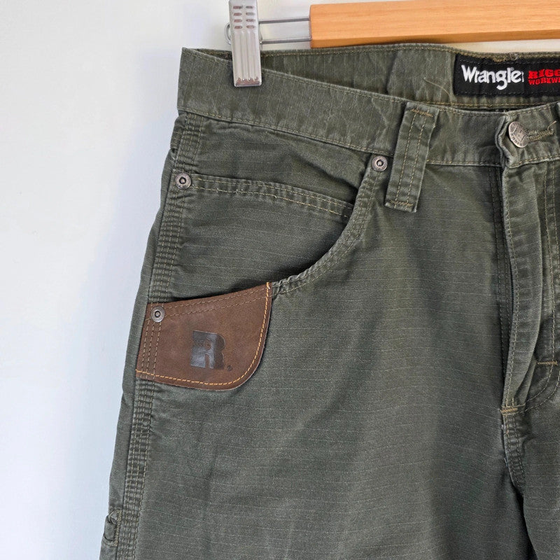 Wrangler khaki straight jeans with utility pockets and sturdy fabric.