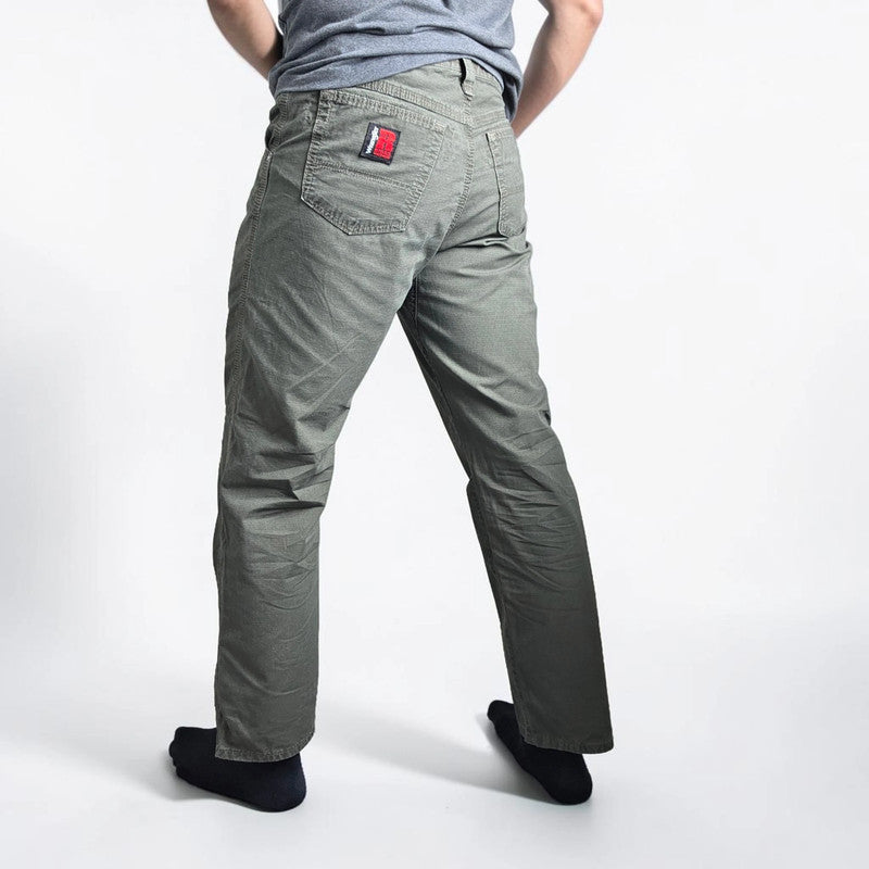 Wrangler khaki straight jeans with utility pockets and sturdy fabric.