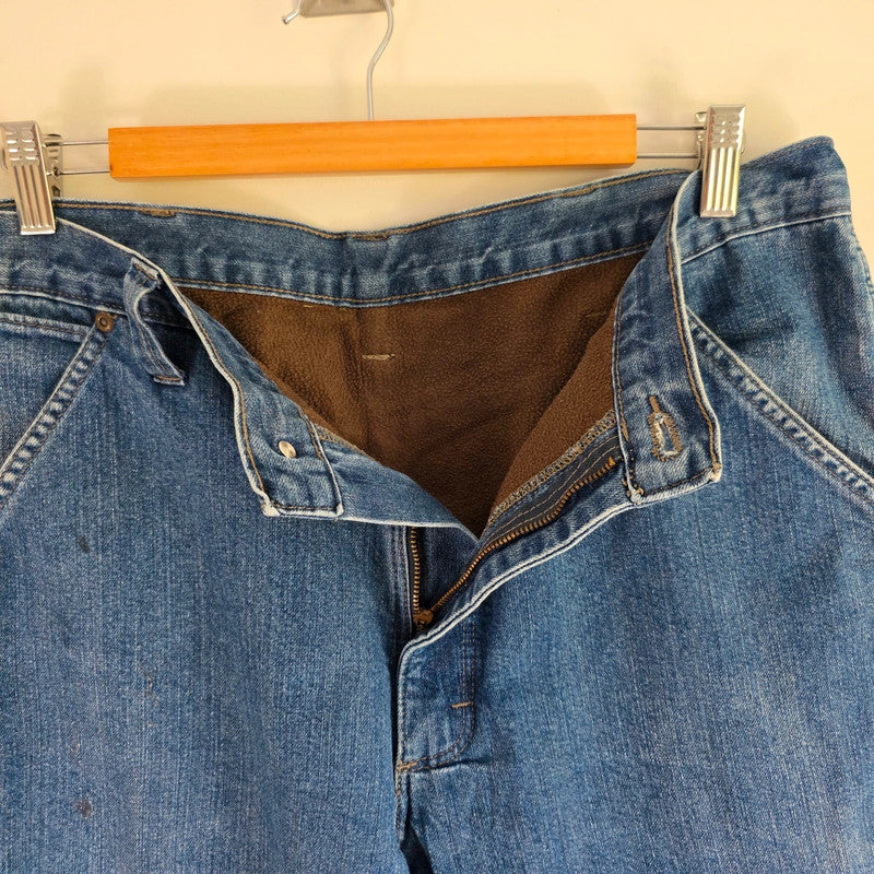 Wrangler blue straight jeans fleece lined with utility pockets and light wear.