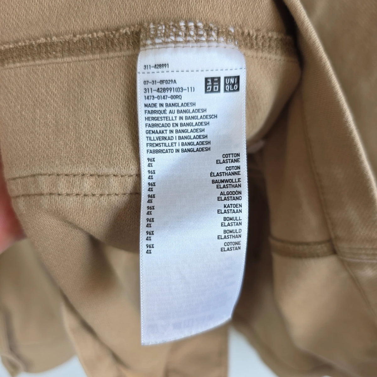 Uniqlo beige chore jacket with three patch pockets and button fastening, cotton stretch fabric.