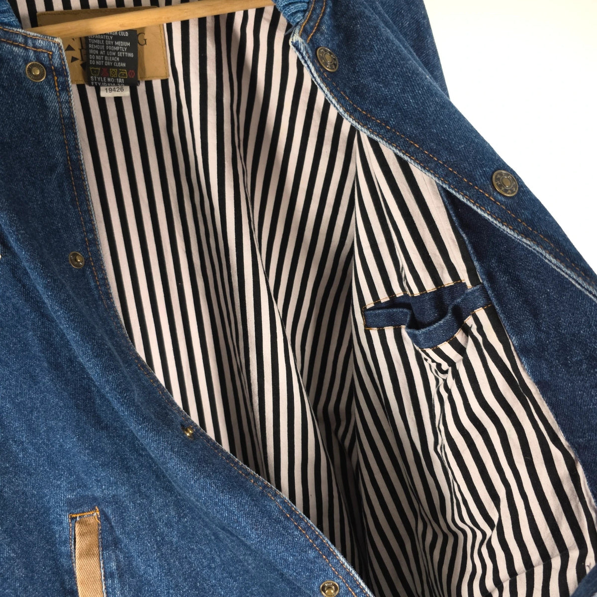 M&M's blue denim varsity bomber jacket with embroidered characters and tan sleeves.