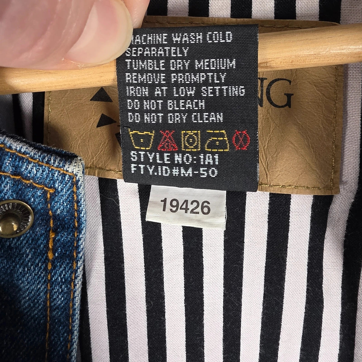 M&M's blue denim varsity bomber jacket with embroidered characters and tan sleeves.