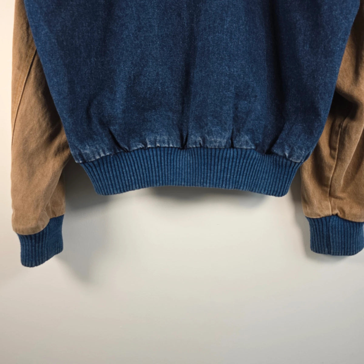 M&M's blue denim varsity bomber jacket with embroidered characters and tan sleeves.
