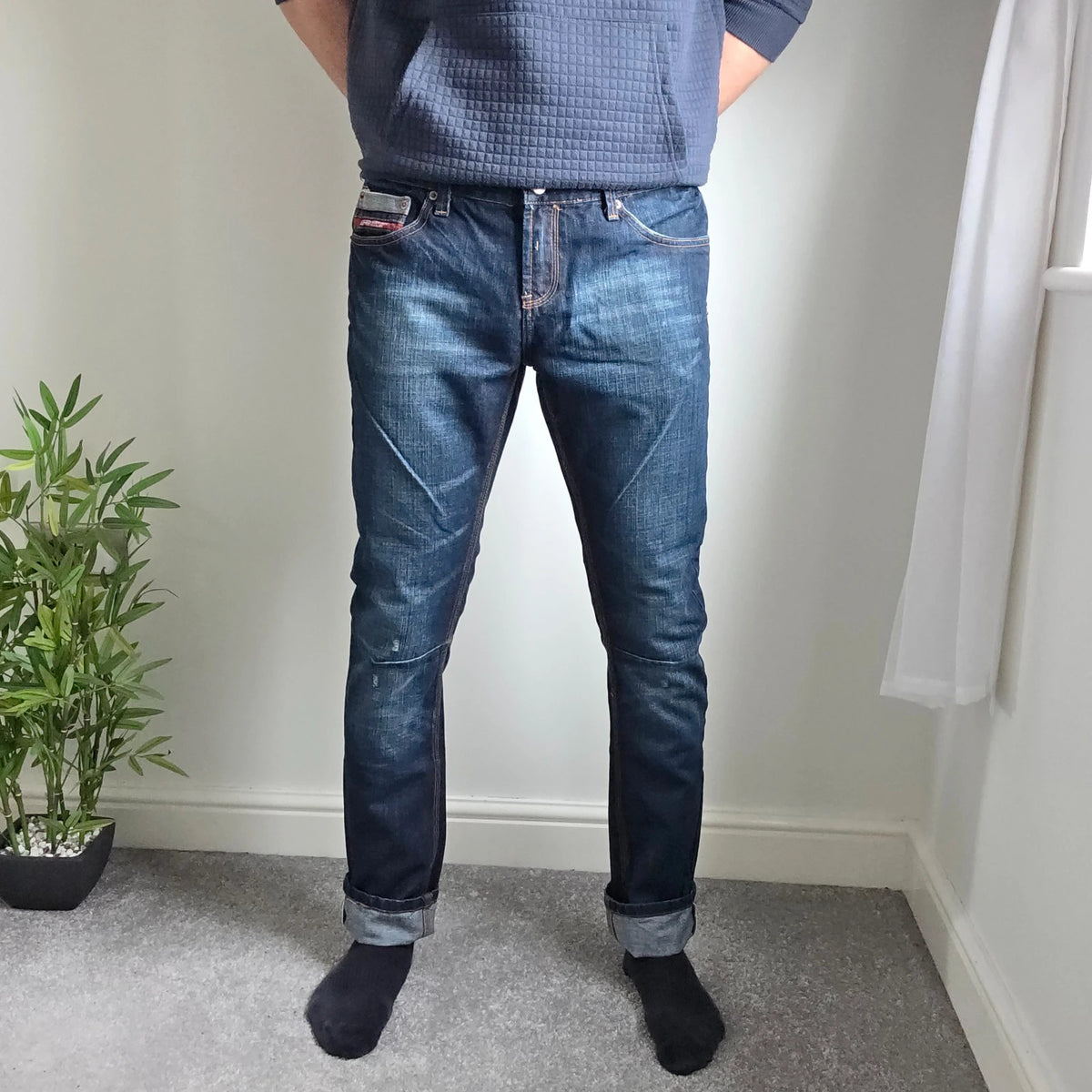 Superdry blue selvedge jeans with contrast stitching and lightly distressed details.
