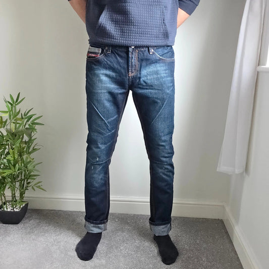 Superdry blue selvedge jeans with contrast stitching and lightly distressed details.