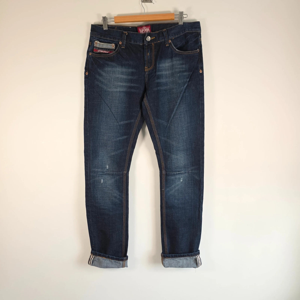 Superdry blue selvedge jeans with contrast stitching and lightly distressed details.
