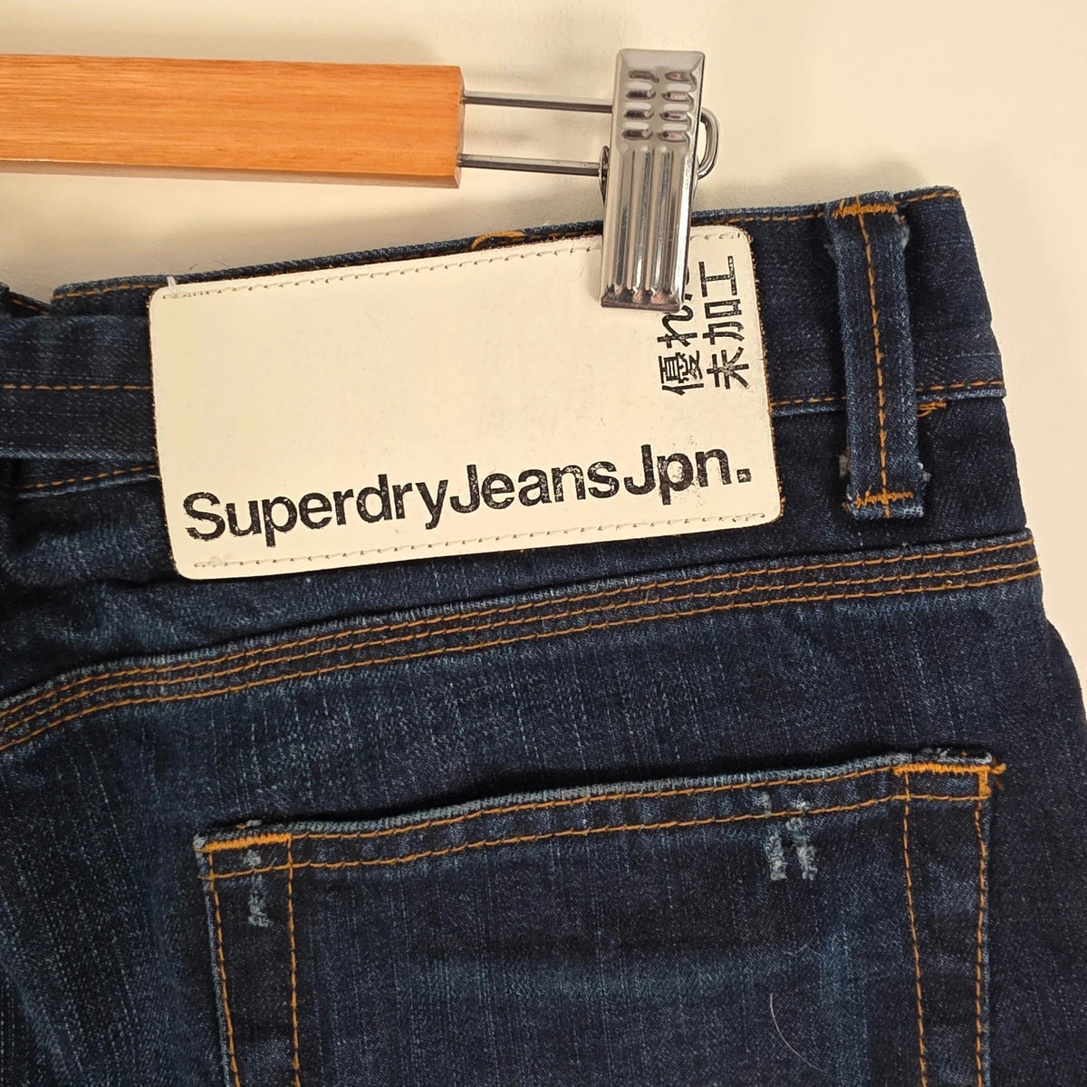 Superdry blue selvedge jeans with contrast stitching and lightly distressed details.