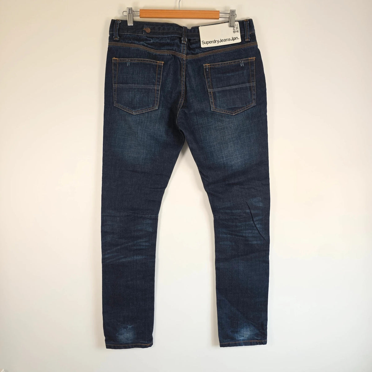 Superdry blue selvedge jeans with contrast stitching and lightly distressed details.