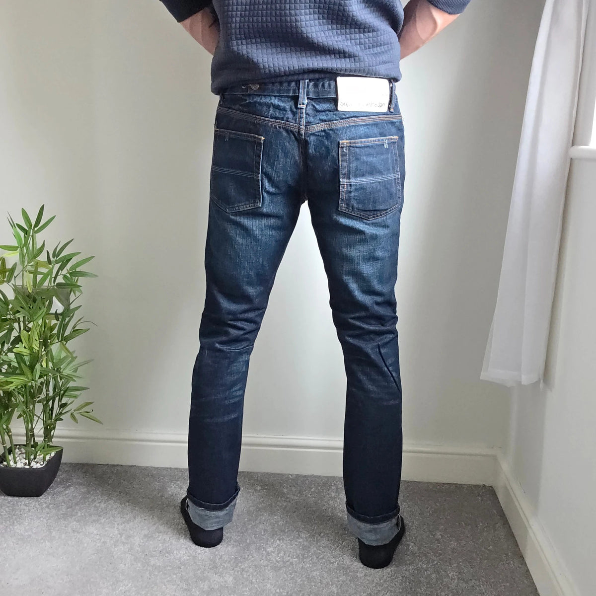 Superdry blue selvedge jeans with contrast stitching and lightly distressed details.