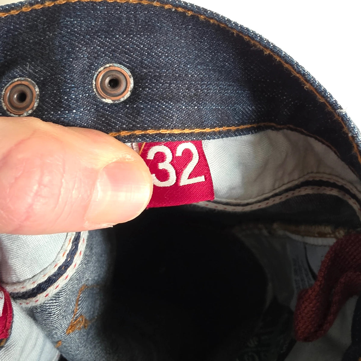 Superdry blue selvedge jeans with contrast stitching and lightly distressed details.