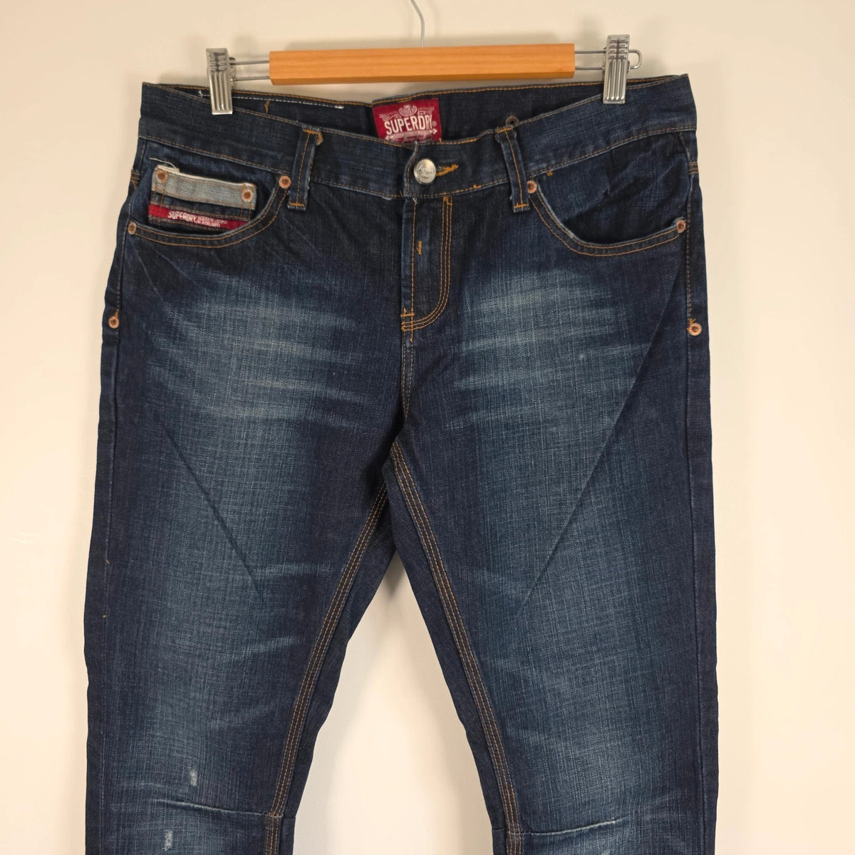 Superdry blue selvedge jeans with contrast stitching and lightly distressed details.