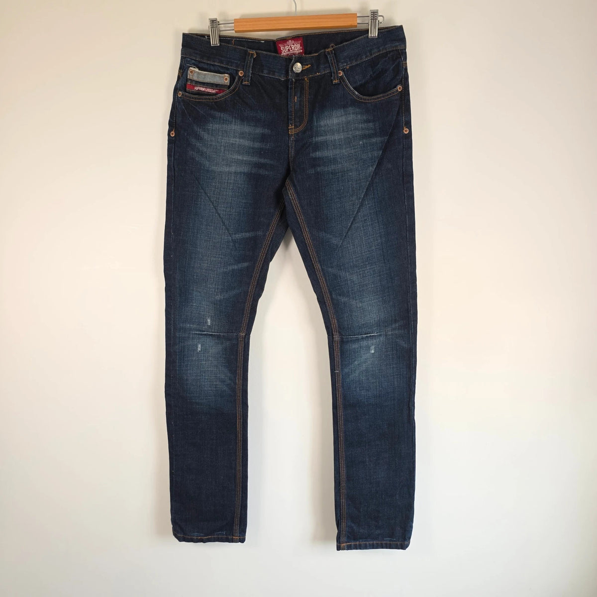 Superdry blue selvedge jeans with contrast stitching and lightly distressed details.