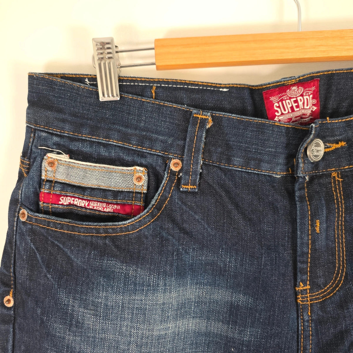 Superdry blue selvedge jeans with contrast stitching and lightly distressed details.