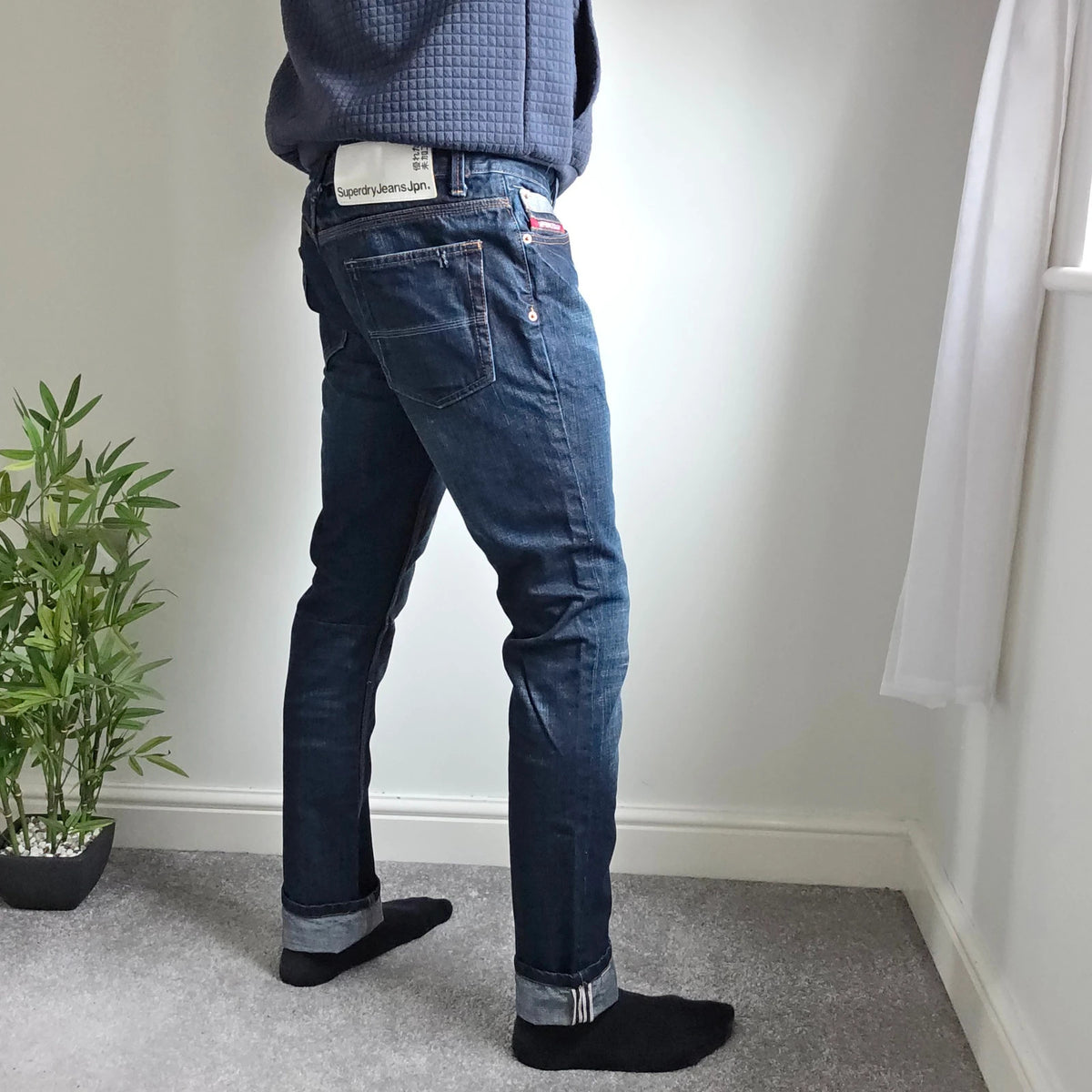 Superdry blue selvedge jeans with contrast stitching and lightly distressed details.
