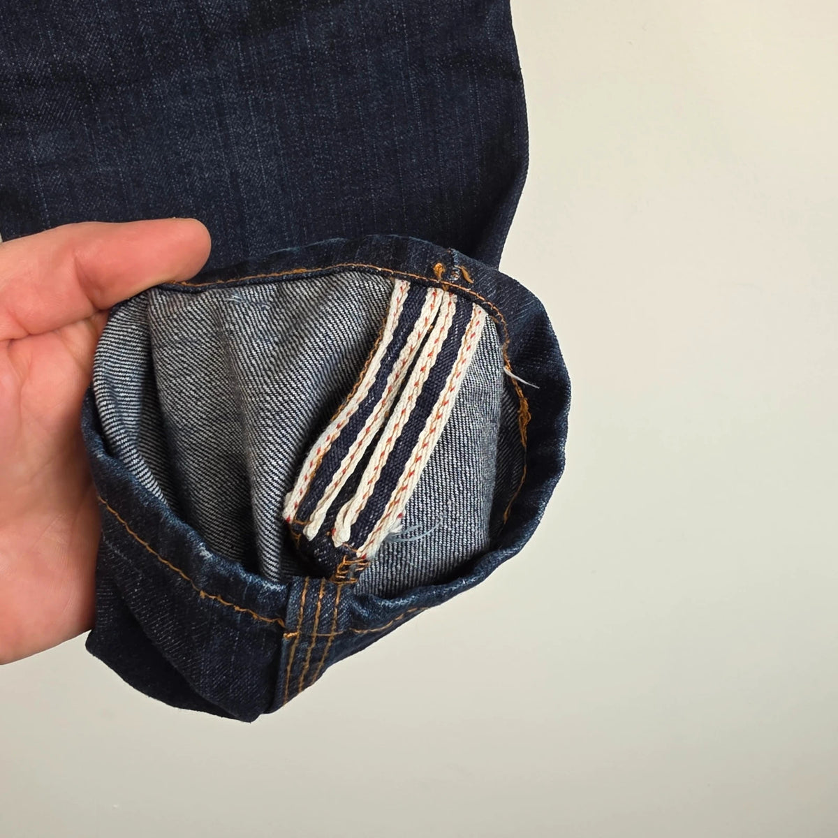 Superdry blue selvedge jeans with contrast stitching and lightly distressed details.