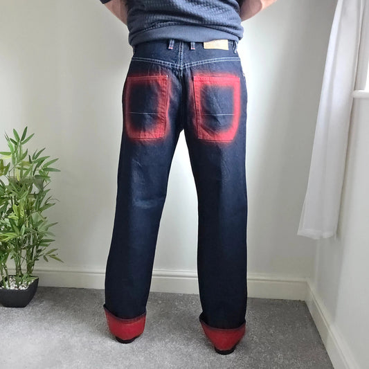 Mecca navy straight jeans with hand-painted red pockets and contrasting cuffs.
