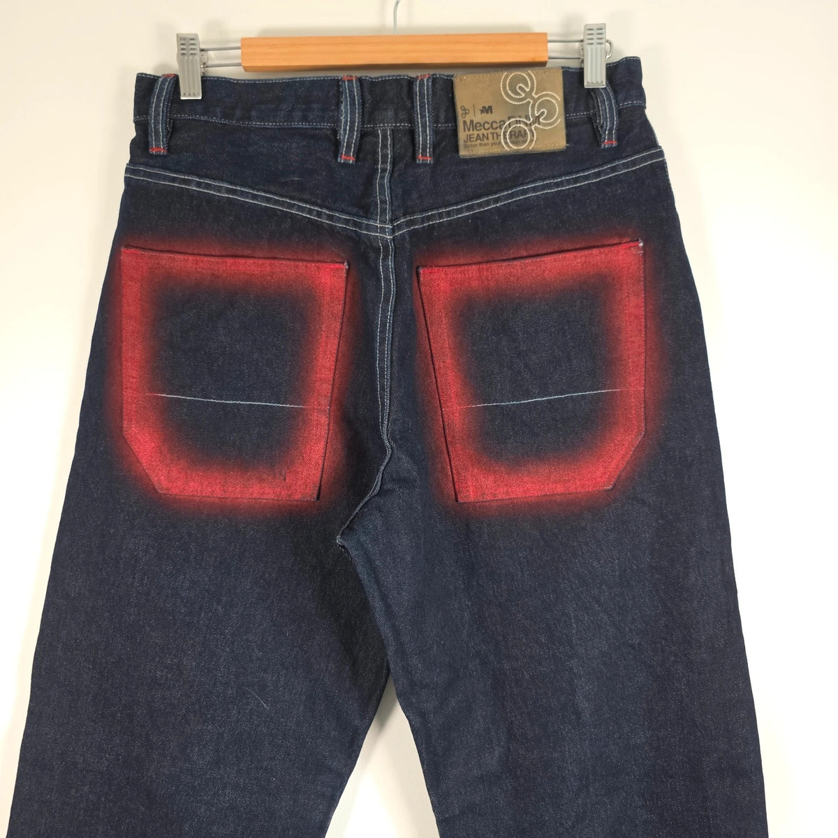 Mecca navy straight jeans with hand-painted red pockets and contrasting cuffs.