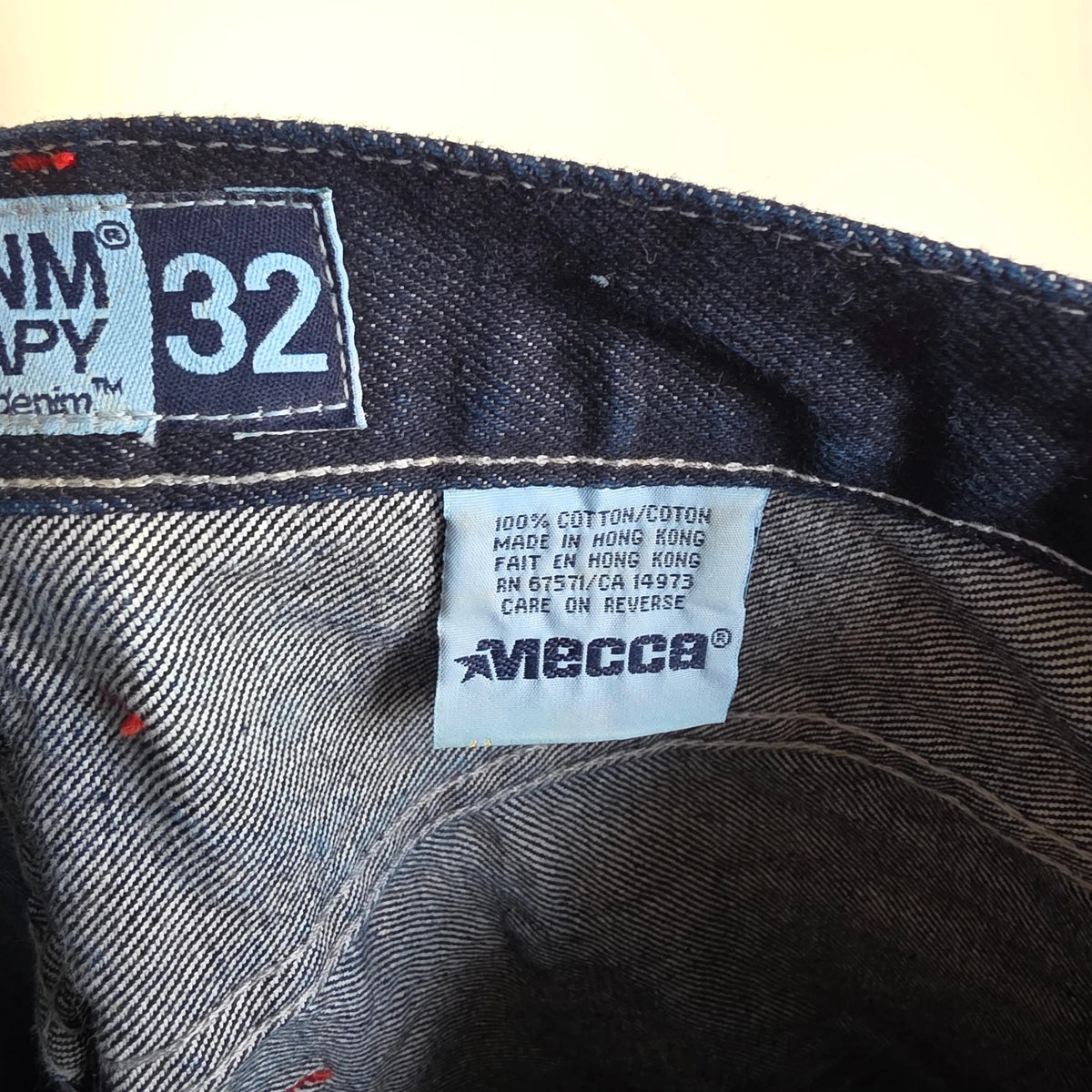 Mecca navy straight jeans with hand-painted red pockets and contrasting cuffs.