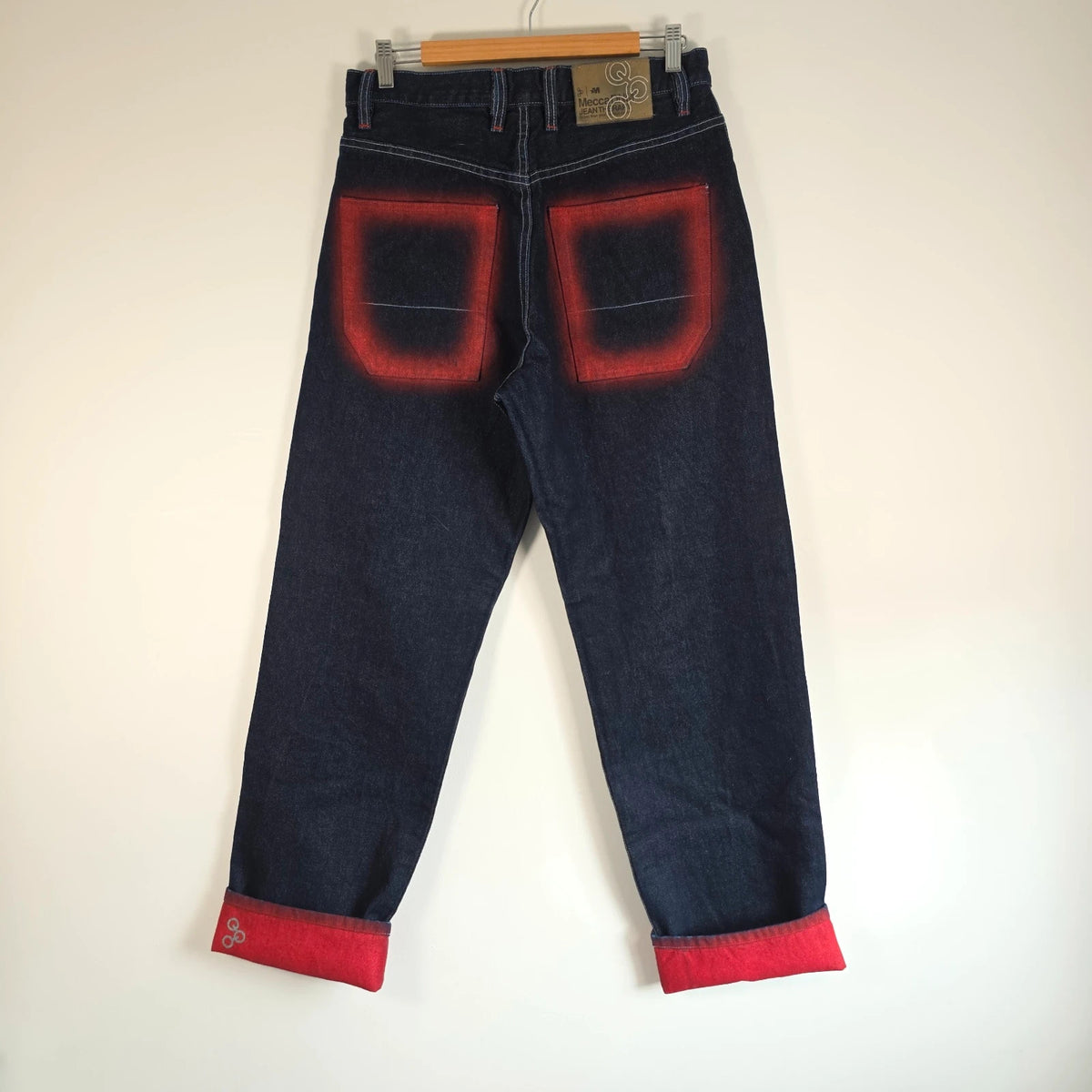 Mecca navy straight jeans with hand-painted red pockets and contrasting cuffs.
