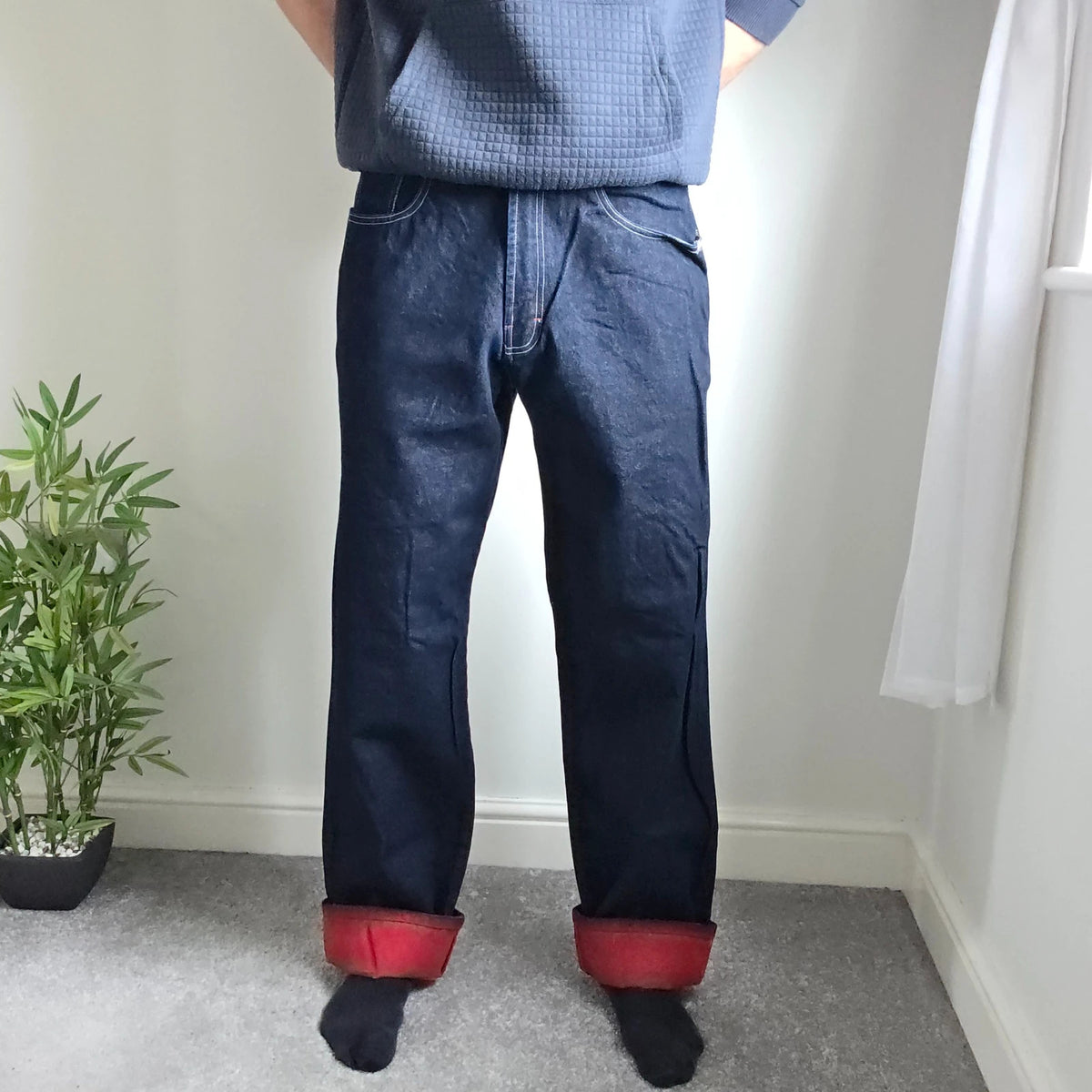 Mecca navy straight jeans with hand-painted red pockets and contrasting cuffs.