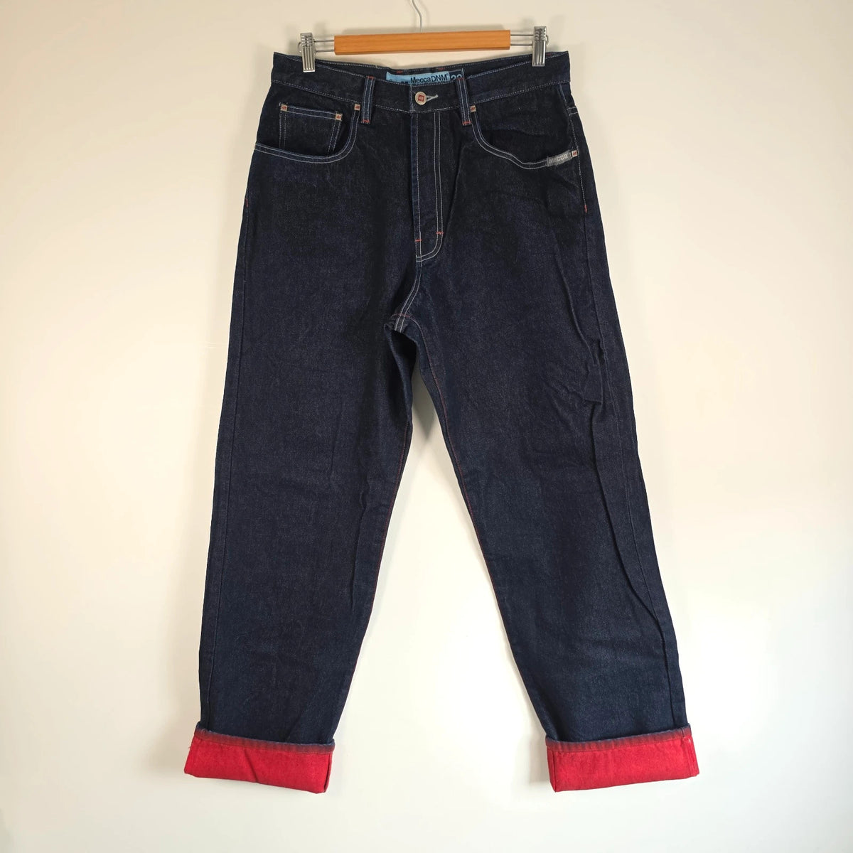 Mecca navy straight jeans with hand-painted red pockets and contrasting cuffs.