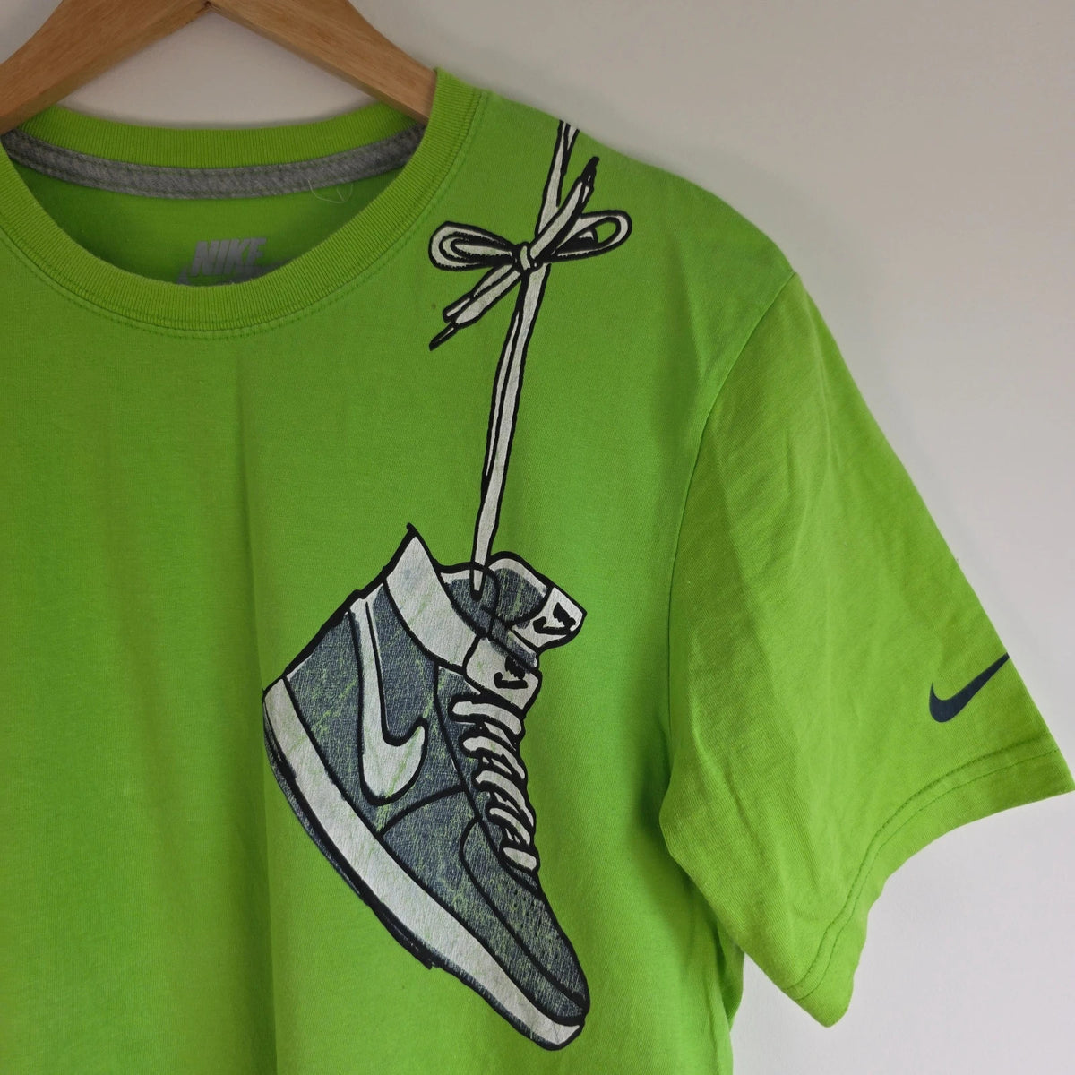 Nike graphic T-shirt bright green sneaker print Y2K streetwear style.