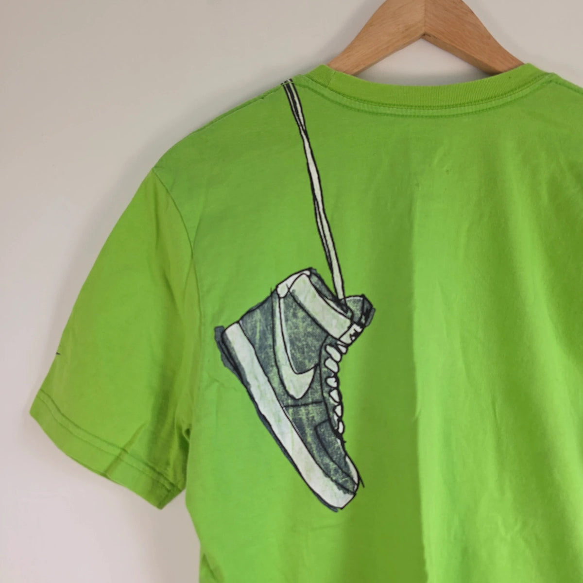 Nike graphic T-shirt bright green sneaker print Y2K streetwear style.