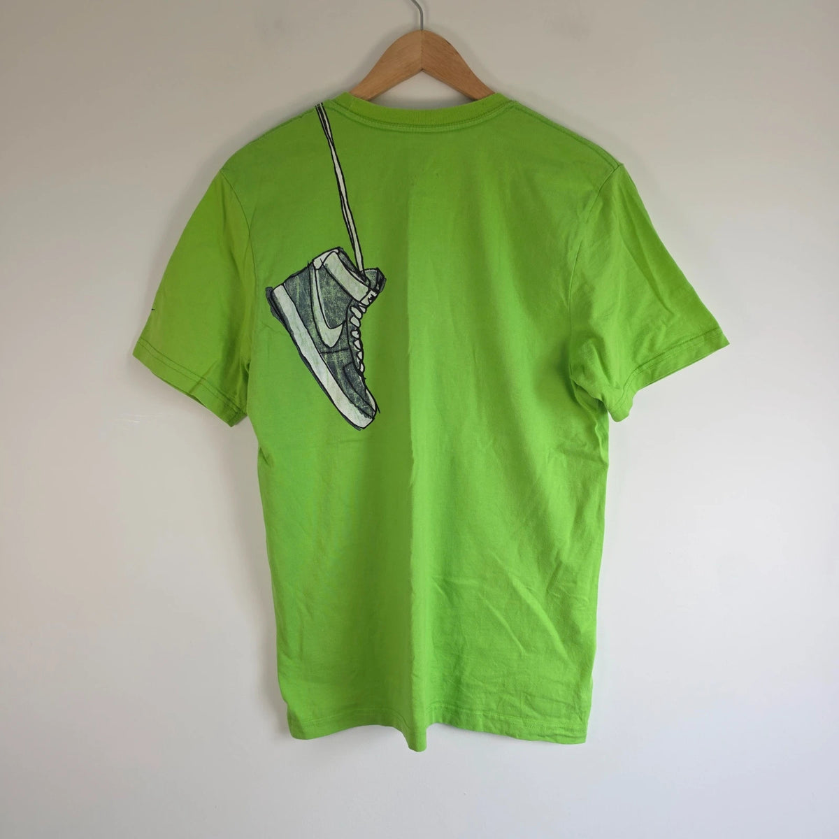Nike graphic T-shirt bright green sneaker print Y2K streetwear style.