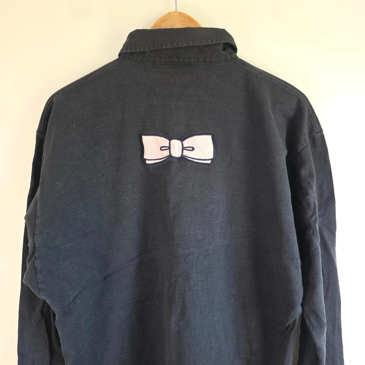 Eden Park navy striped rugby shirt with pink bow tie appliqué and long sleeves.