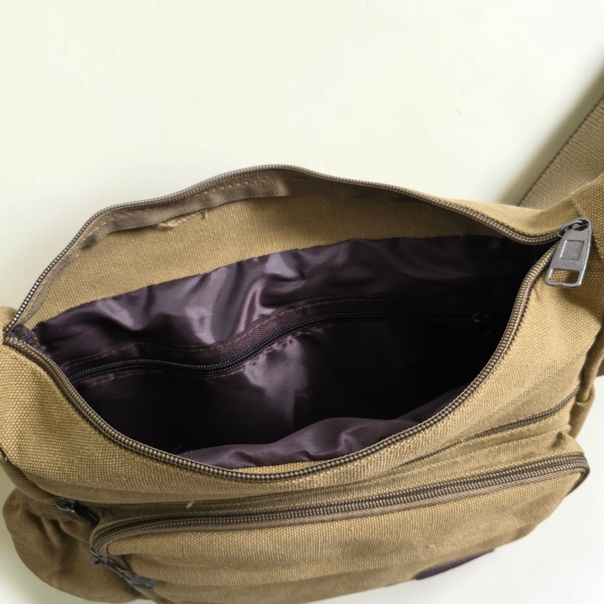 Unbranded multi pocket canvas crossbody bag with adjustable strap and various colors.