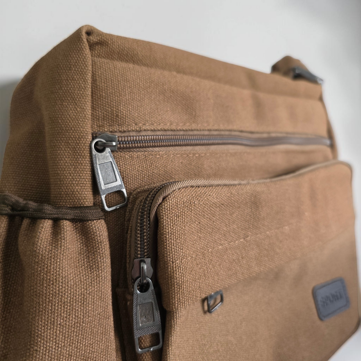 Unbranded multi pocket canvas crossbody bag with adjustable strap and various colors.