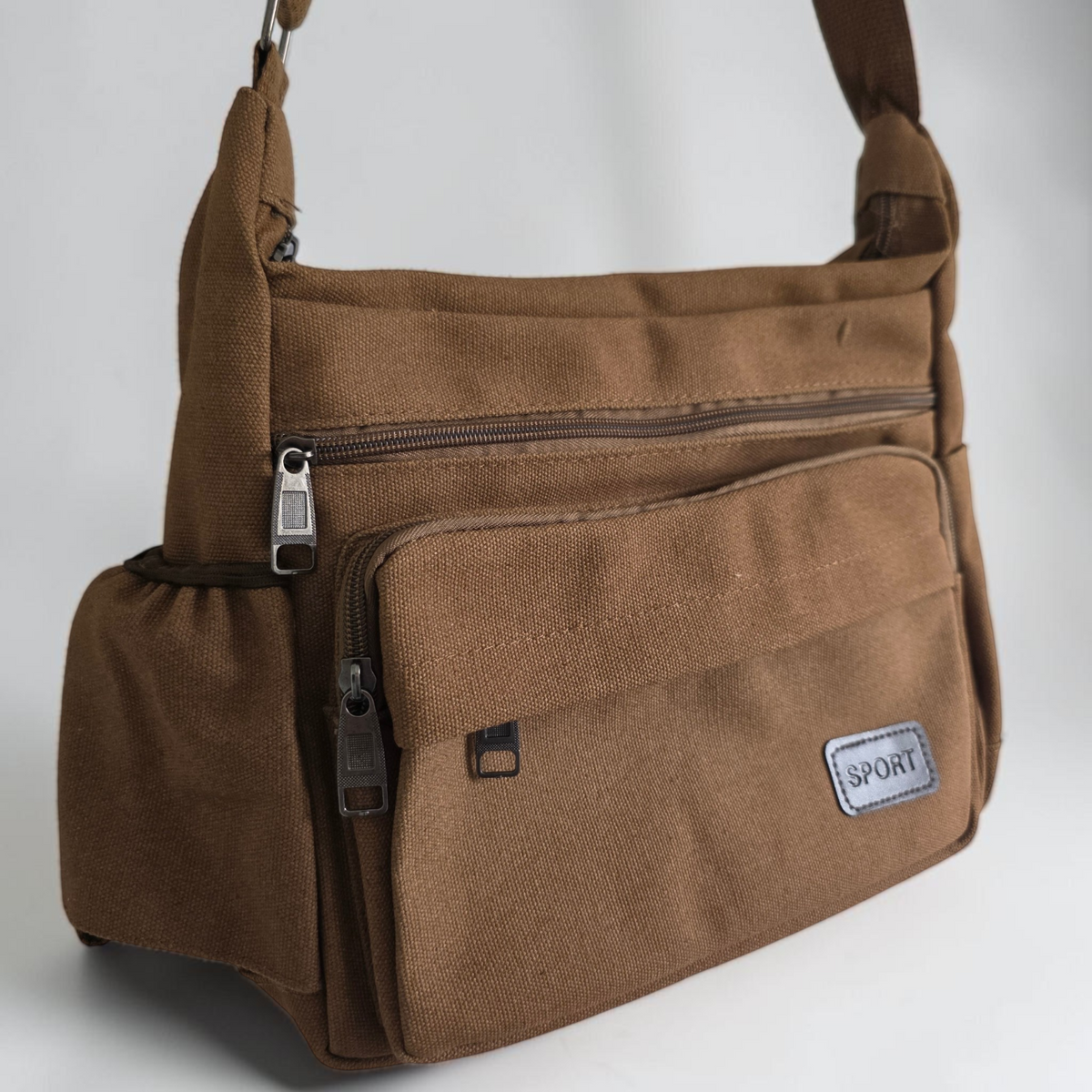 Unbranded multi pocket canvas crossbody bag with adjustable strap and various colors.