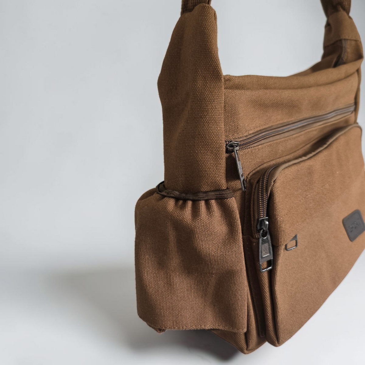 Unbranded multi pocket canvas crossbody bag with adjustable strap and various colors.