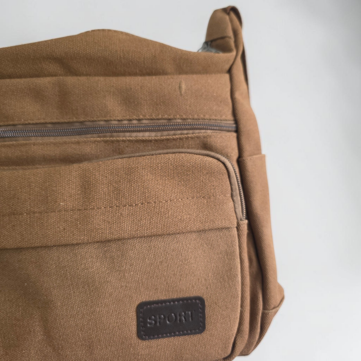 Unbranded multi pocket canvas crossbody bag with adjustable strap and various colors.