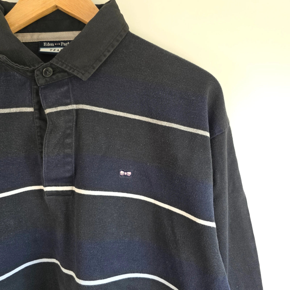 Eden Park navy striped rugby shirt with pink bow tie appliqué and long sleeves.