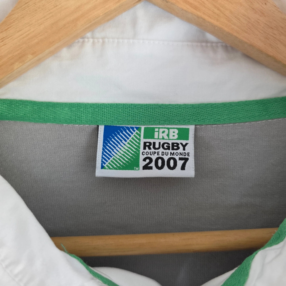 Rugby World Cup grey pink long sleeve polo shirt with IRB logo and Stade de France detail.
