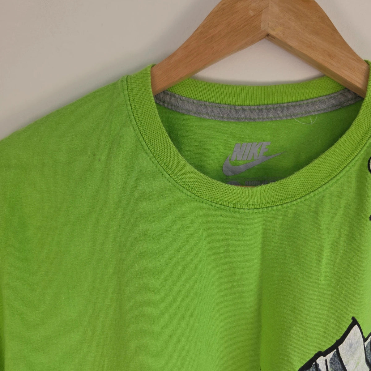 Nike graphic T-shirt bright green sneaker print Y2K streetwear style.
