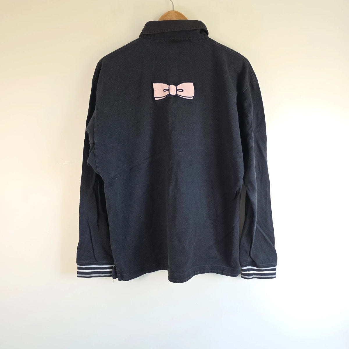 Eden Park navy striped rugby shirt with pink bow tie appliqué and long sleeves.