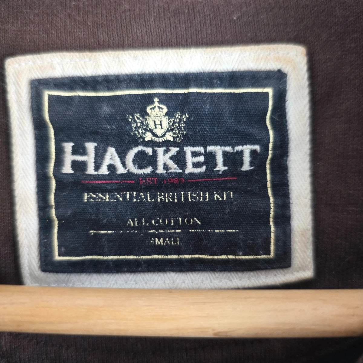 Hackett brown rugby polo shirt with navy collar, embroidered patches, and large back design.