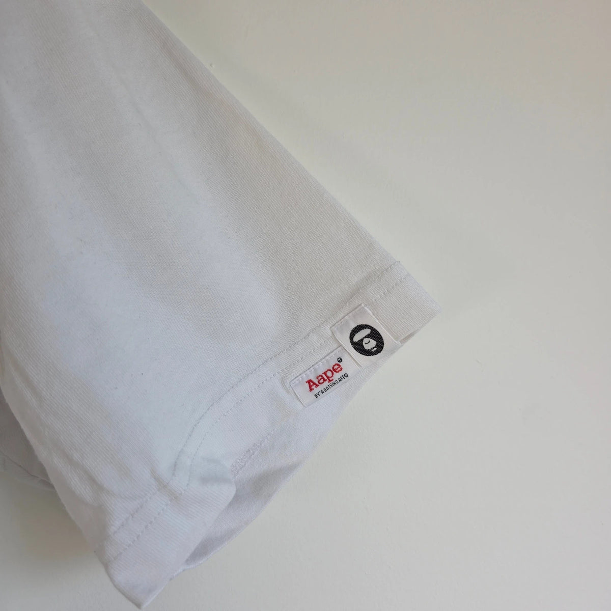AAPE by A Bathing Ape white graphic T-shirt featuring Ape Universe skull print.