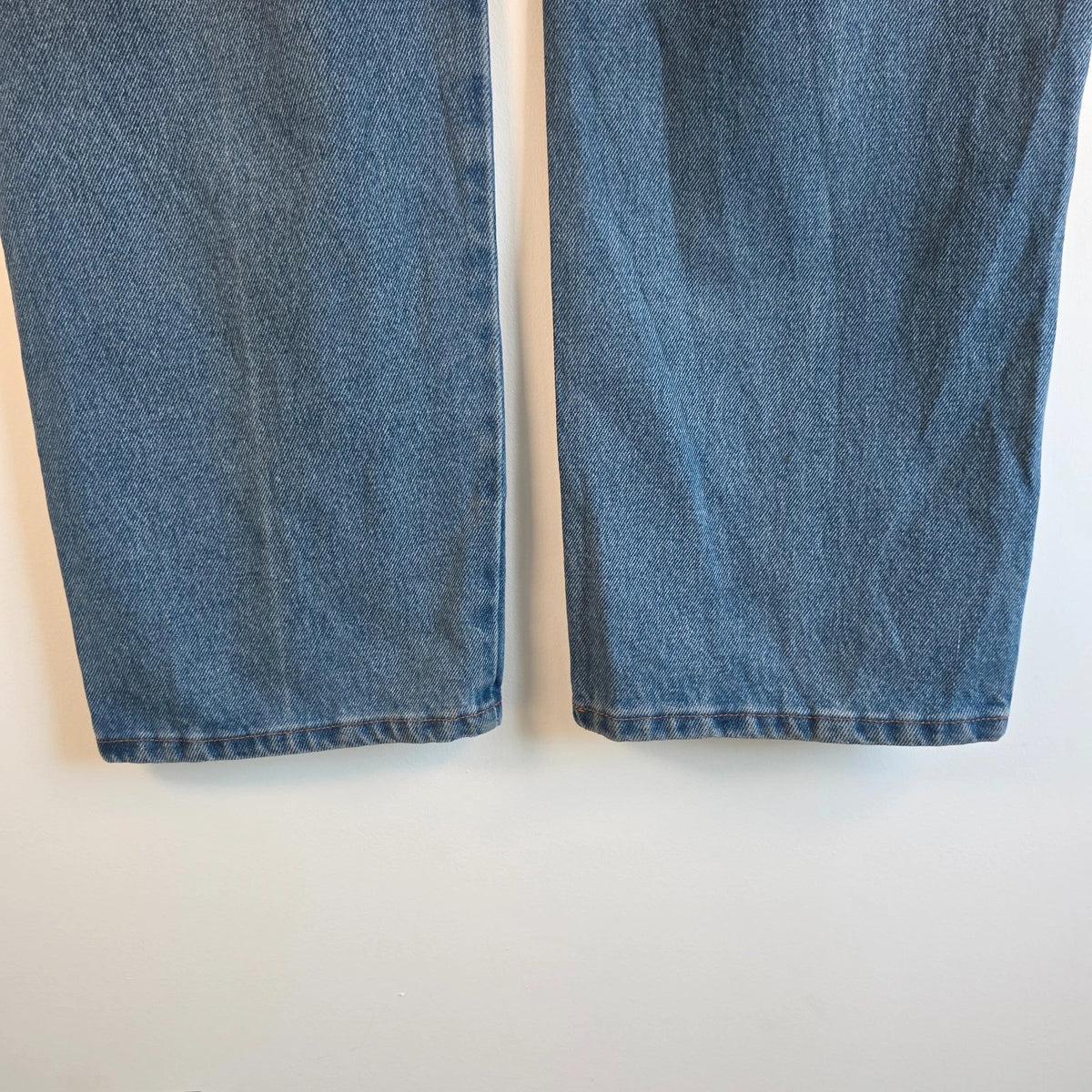 Rustler blue carpenter jeans with utility pockets and hammer loop detailing.