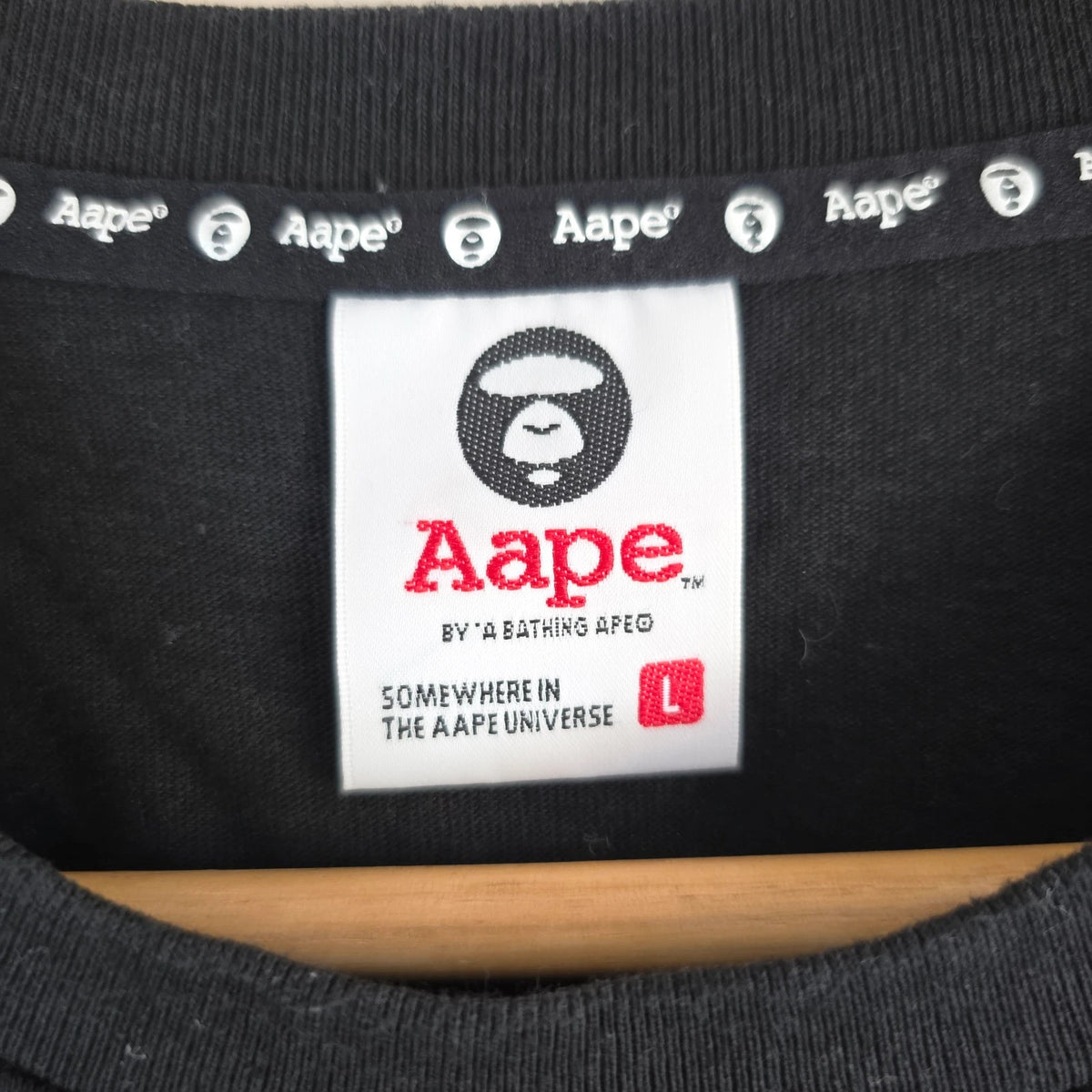 AAPE by A Bathing Ape black T-shirt with large camo ape head graphic and branded sleeve.