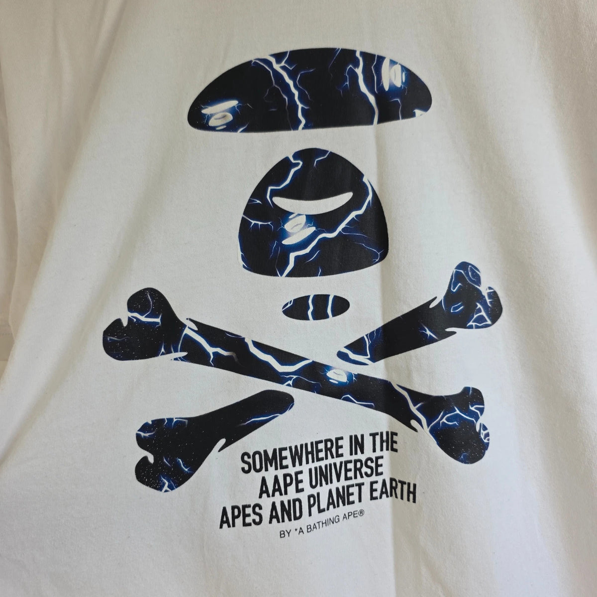 AAPE by A Bathing Ape white graphic T-shirt featuring Ape Universe skull print.