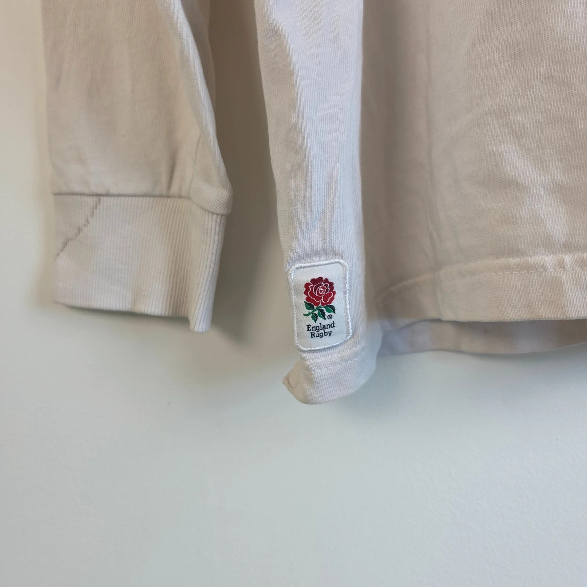 England Rugby white long sleeve polo shirt with rose logo and rugby jersey style.
